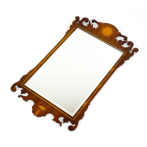 1586 - A Regency style yew wood veneered wall mirror inlaid with marquetry decoration. 20