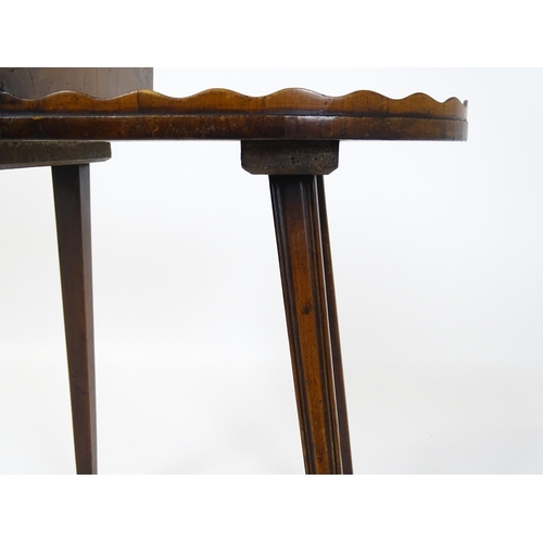 1623 - A 19thC yew wood cutlery stand / butlers Canterbury with a hinged lid, pierced handle and raised on ... 