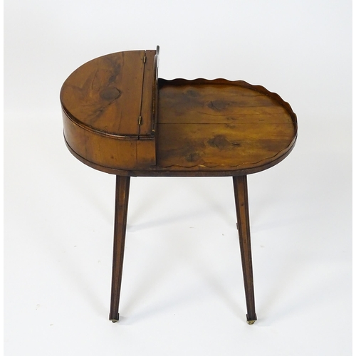 1623 - A 19thC yew wood cutlery stand / butlers Canterbury with a hinged lid, pierced handle and raised on ... 