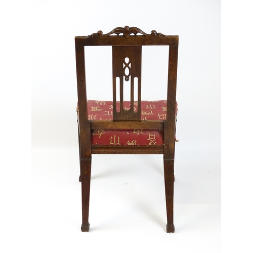 1627 - An Edwardian mahogany side chair with a floral carved cresting rail above a central pierced back spl... 