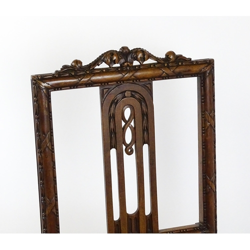 1627 - An Edwardian mahogany side chair with a floral carved cresting rail above a central pierced back spl... 