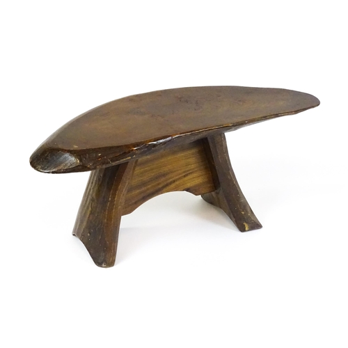 1638 - A 20thC rustic oak stool with a driftwood style top above a shaped base. 27