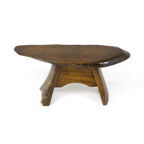 1638 - A 20thC rustic oak stool with a driftwood style top above a shaped base. 27