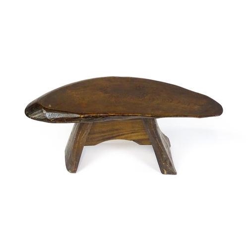 1638 - A 20thC rustic oak stool with a driftwood style top above a shaped base. 27