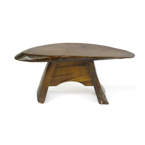 1638 - A 20thC rustic oak stool with a driftwood style top above a shaped base. 27