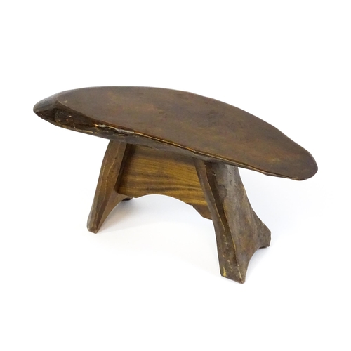 1638 - A 20thC rustic oak stool with a driftwood style top above a shaped base. 27