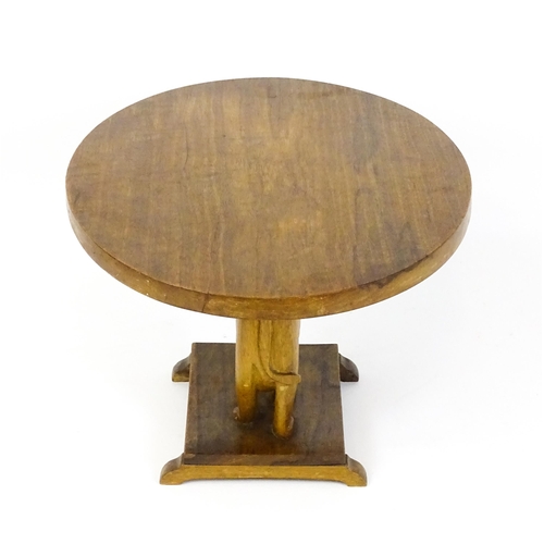 1639 - A mid 20thC teak occasional table with an oval top above an elephant formed pedestal and rectangular... 