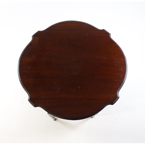 1640 - An Edwardian mahogany occasional table with a shaped top above a lower under tier with a turned gall... 