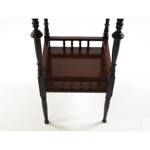 1640 - An Edwardian mahogany occasional table with a shaped top above a lower under tier with a turned gall... 