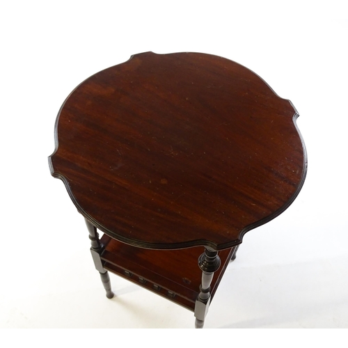 1640 - An Edwardian mahogany occasional table with a shaped top above a lower under tier with a turned gall... 