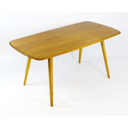 1649 - Vintage / Retro: An elm Ercol dining table raised on four tapering legs. 60