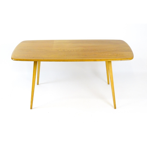 1649 - Vintage / Retro: An elm Ercol dining table raised on four tapering legs. 60