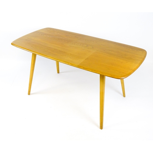 1649 - Vintage / Retro: An elm Ercol dining table raised on four tapering legs. 60