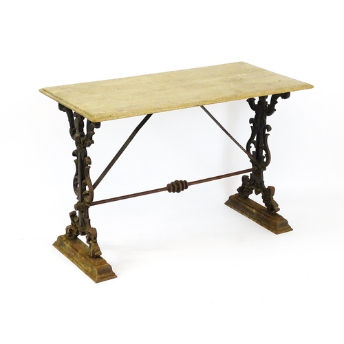 820 - Garden / Architectural: A late 19thC / early 20thC table with a cast iron base. 44