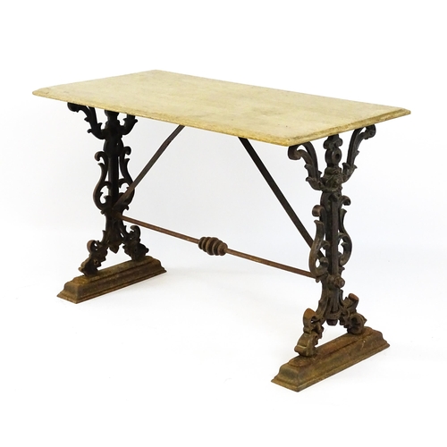 820 - Garden / Architectural: A late 19thC / early 20thC table with a cast iron base. 44