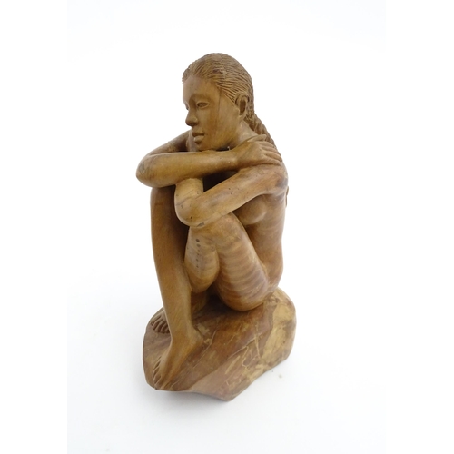 1118 - A 20thC carved wooden sculpture depicting a seated female nude. Signed S. Connor lower. Approx. 11