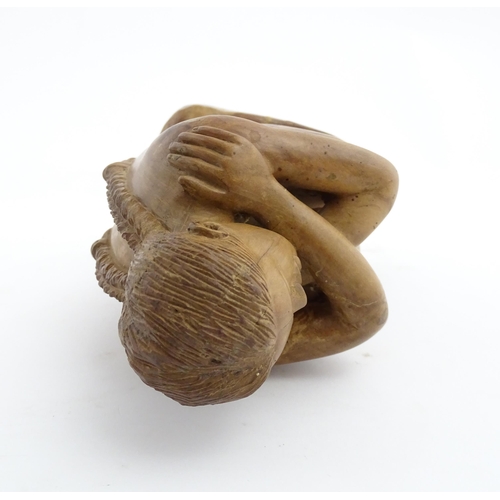 1118 - A 20thC carved wooden sculpture depicting a seated female nude. Signed S. Connor lower. Approx. 11