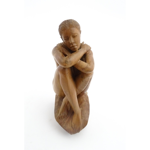 1118 - A 20thC carved wooden sculpture depicting a seated female nude. Signed S. Connor lower. Approx. 11