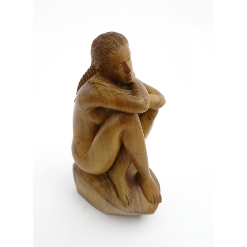 1118 - A 20thC carved wooden sculpture depicting a seated female nude. Signed S. Connor lower. Approx. 11