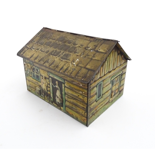 1122 - A novelty S. Henderson & Sons Ltd. biscuit tin formed as a log cabin, with figures, a dog and a hors... 