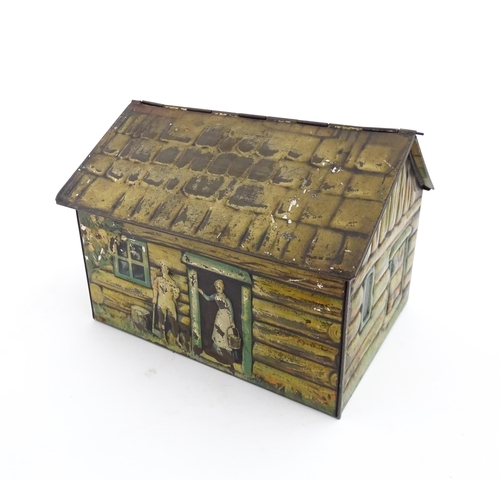 1122 - A novelty S. Henderson & Sons Ltd. biscuit tin formed as a log cabin, with figures, a dog and a hors... 