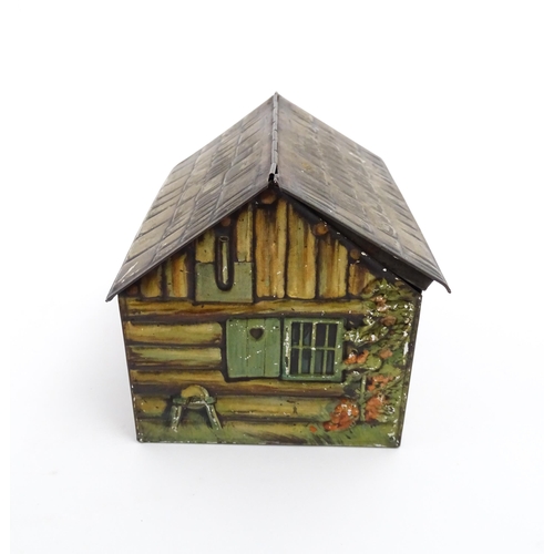 1122 - A novelty S. Henderson & Sons Ltd. biscuit tin formed as a log cabin, with figures, a dog and a hors... 