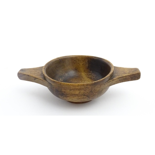 1128 - Treen : A 19thC Scottish turned wooden quaich. Approx. 4 3/4