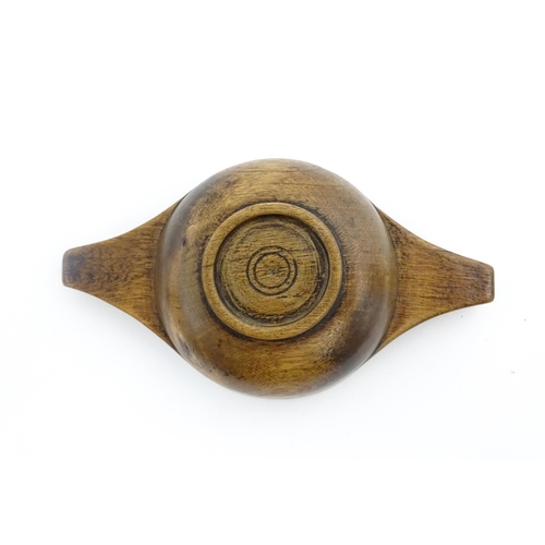 1128 - Treen : A 19thC Scottish turned wooden quaich. Approx. 4 3/4