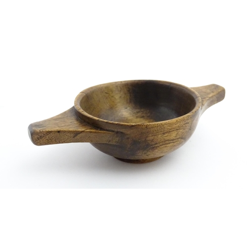 1128 - Treen : A 19thC Scottish turned wooden quaich. Approx. 4 3/4