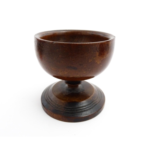 1178 - Treen : A 19thC fruitwood salt of pedestal form with banded detail to foot. Approx. 3