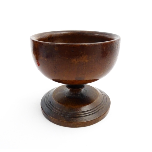 1178 - Treen : A 19thC fruitwood salt of pedestal form with banded detail to foot. Approx. 3