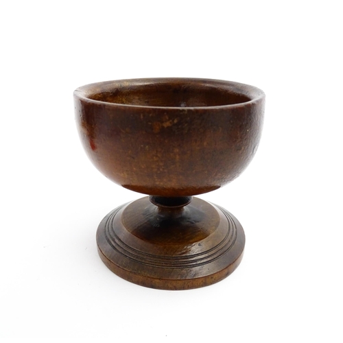 1178 - Treen : A 19thC fruitwood salt of pedestal form with banded detail to foot. Approx. 3