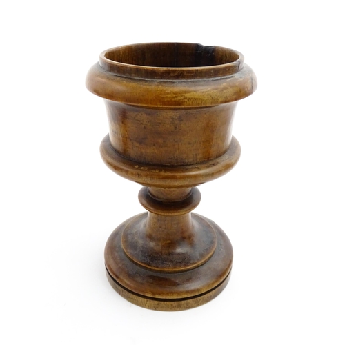 1179 - Treen : A 19thC turned wooden pedestal salt of goblet form. Approx. 5 1/2