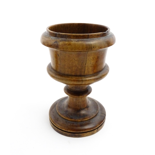 1179 - Treen : A 19thC turned wooden pedestal salt of goblet form. Approx. 5 1/2