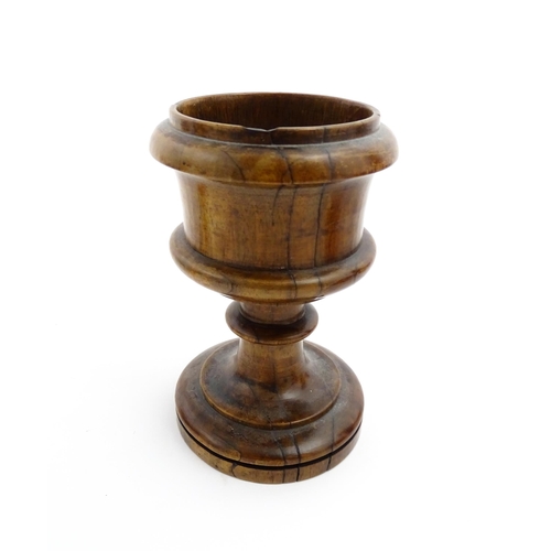 1179 - Treen : A 19thC turned wooden pedestal salt of goblet form. Approx. 5 1/2