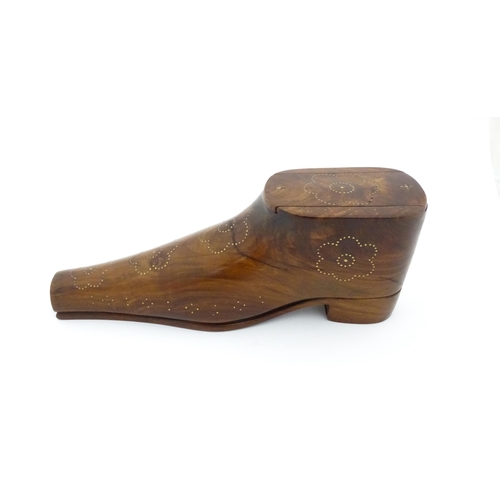 1183 - Treen : A large 20thC carved table snuff box formed as a shoe with brass studwork floral decoration,... 