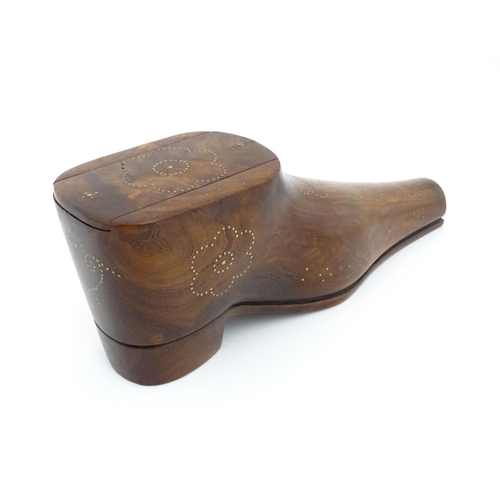 1183 - Treen : A large 20thC carved table snuff box formed as a shoe with brass studwork floral decoration,... 