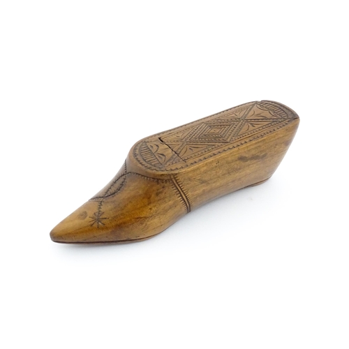 1185 - Treen : A 19thC Continental shoe table snuff box with chip carved decoration to the sliding top. App... 