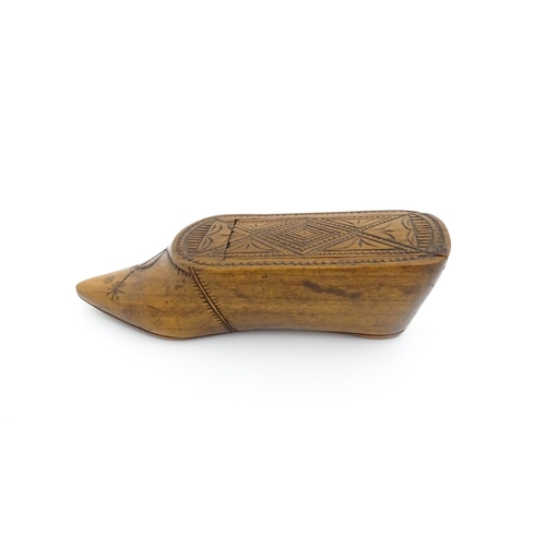 1185 - Treen : A 19thC Continental shoe table snuff box with chip carved decoration to the sliding top. App... 