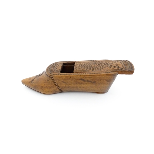 1185 - Treen : A 19thC Continental shoe table snuff box with chip carved decoration to the sliding top. App... 