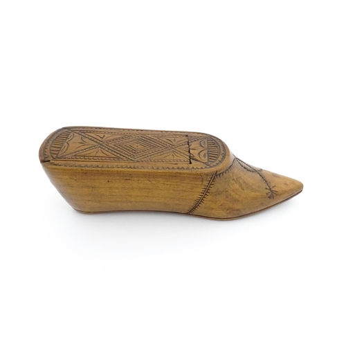 1185 - Treen : A 19thC Continental shoe table snuff box with chip carved decoration to the sliding top. App... 