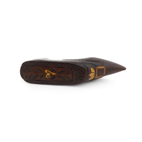 1187 - Treen : A 19thC Continental shoe snuff box with sliding top, decorated with carved and inlaid decora... 