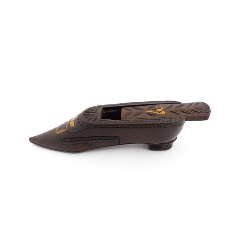 1187 - Treen : A 19thC Continental shoe snuff box with sliding top, decorated with carved and inlaid decora... 