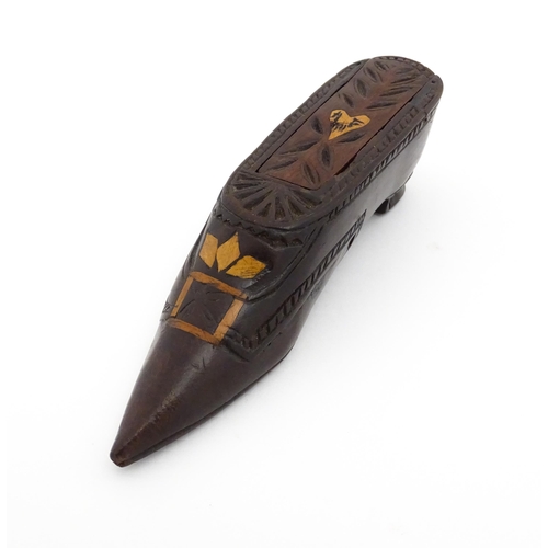 1187 - Treen : A 19thC Continental shoe snuff box with sliding top, decorated with carved and inlaid decora... 