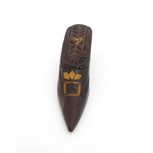 1187 - Treen : A 19thC Continental shoe snuff box with sliding top, decorated with carved and inlaid decora... 