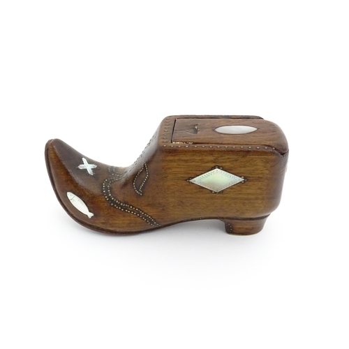 1189 - Treen : A 19thC Continental shoe table snuff box with sliding lid and upturned toe decorated with br... 