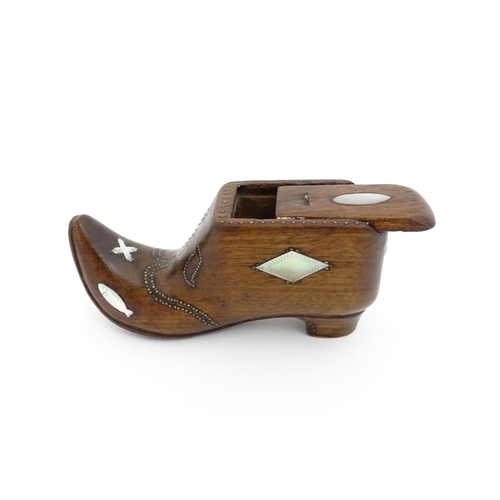 1189 - Treen : A 19thC Continental shoe table snuff box with sliding lid and upturned toe decorated with br... 