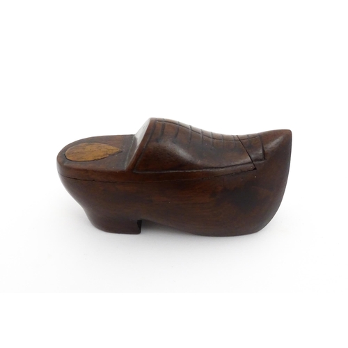 1192 - Treen : A 19thC Continental shoe snuff box the swivel top with carved and inlaid decoration. Approx.... 