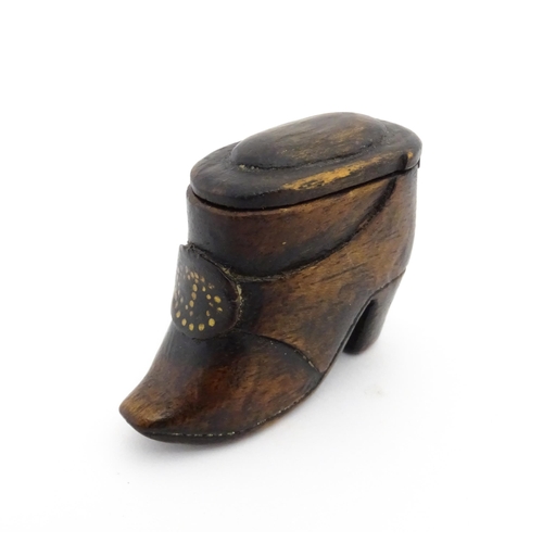 1197 - Treen : A 19thC Continental shoe snuff box of boot form with sliding lid and brass studwork detail t... 