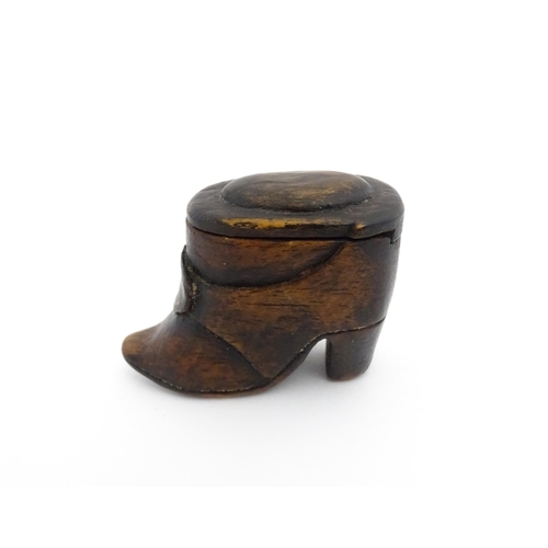 1197 - Treen : A 19thC Continental shoe snuff box of boot form with sliding lid and brass studwork detail t... 